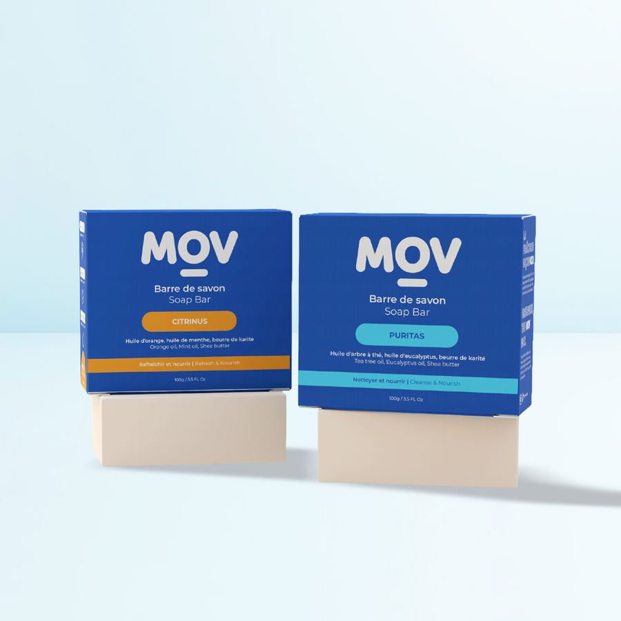 Two MovLabs natural soap bars with their packaging on a light blue background